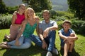 Portrait of happy caucasian couple with daughter and son outdoors, sitting in sunny garden Royalty Free Stock Photo