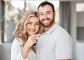 Portrait of happy caucasian couple holding up house keys. Affectionate couple looking happy after buying their first or Royalty Free Stock Photo