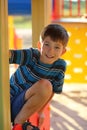 Portrait of happy caucasian eight year old smiling boy on the sunlit summer playground