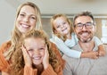 Portrait of a happy Caucasian family of four relaxing in the living room at home. Loving smiling family being Royalty Free Stock Photo