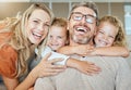 Portrait of a happy Caucasian family of four relaxing in the living room at home. Loving smiling family being Royalty Free Stock Photo