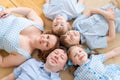 Portrait happy caucasian family posing on floor house, lying on carpet Royalty Free Stock Photo