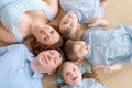 Portrait happy caucasian family posing on floor house, lying on carpet Royalty Free Stock Photo