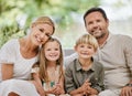 Portrait of a happy caucasian family with two children sitting on the couch at home. Adorable little girl and boy Royalty Free Stock Photo