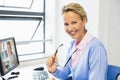 Portrait of happy caucasian female teacher using computer on video call with schoolboy