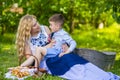 Portrait of Happy Caucasian Mother With Her Little Kid. Posing with Basket Full of Bread Rings Outdoors Royalty Free Stock Photo