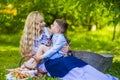 Portrait of Happy Caucasian Mother With Her Little Kid. Posing with Basket Full of Bread Rings Outdoors Royalty Free Stock Photo