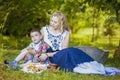 Portrait of Happy Caucasian Mother and Her Little Kid.Posing with Basket Full of Bread Rings Outdoors Royalty Free Stock Photo