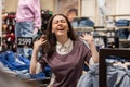 Portrait of happy Caucasian smiling woman enjoying sale in clothing store. Concept of holiday and seasonal discounts Royalty Free Stock Photo