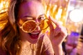 Portrait of happy caucasian woman looking over sunglasses and smiling to camera at a nightclub Royalty Free Stock Photo