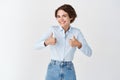 Portrait of happy caucasian woman show thumbs up and smile in approval, praise good job, well done gesture, like and Royalty Free Stock Photo