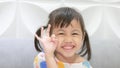 Portrait of happy charming 4 years old cute baby Asian girl, little preschooler child with adorable pigtails hair smiling looking Royalty Free Stock Photo