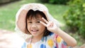 Portrait of happy charming 4 years old cute baby Asian girl, little preschooler child smiling looking at camera showing 2 fingers Royalty Free Stock Photo