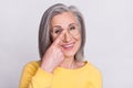 Portrait of happy cheerful beautiful grandmother point finger glasses recommend oculist isolated on grey color