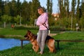 Portrait of happy cheerful beautiful young woman with german shepherd- outdoors Royalty Free Stock Photo