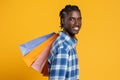 Portrait Of Happy Cheerful Black Man Holding Lots Of Bright Shopping Bags