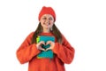 Portrait of a happy cheerful girl in winter red hat showing heart with two hands Royalty Free Stock Photo