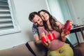 Happy cheerful husband giving present box to his pregnant wife Royalty Free Stock Photo