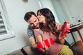 Happy cheerful husband giving present box to his pregnant wife Royalty Free Stock Photo