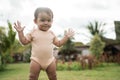 A portrait of a happy and cheerful little boy starting to walk alone