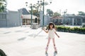 Portrait of a happy and cheerful little girl playing roller skating in the park Royalty Free Stock Photo