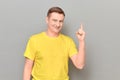 Portrait of happy cheerful mature man raising index finger and smiling Royalty Free Stock Photo