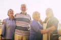 Portrait of happy and cheerful mature senior people enjoying friendship outdoor. Retired group of friends standing and posing for Royalty Free Stock Photo