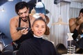 Portrait of smiling man hairdresser cutting woman's hair in salon Royalty Free Stock Photo