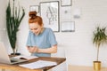 Portrait of happy cheerful redhead young woman using mobile phone. Royalty Free Stock Photo