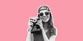 Portrait of happy cheerful smiling young woman photographer taking picture on film camera wearing baseball cap on pink studio Royalty Free Stock Photo