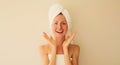 Portrait of happy cheerful surprised laughing woman having fun after shower drying her wet hair with towel wrapped on her head in Royalty Free Stock Photo