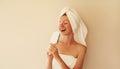 Portrait of happy cheerful woman having fun sings with hair comb and laughing after shower drying her wet hair with towel wrapped Royalty Free Stock Photo