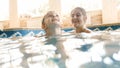 Portrait of happy cheerful young mothet with 3 years old toddler boy playing in the pool at house. Child learning Royalty Free Stock Photo