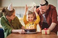 Portrait of happy child boy celebrating birthday with young parents at home Royalty Free Stock Photo