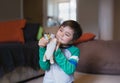 Portrait happy Child boy playing with dog toy in living room, Positive young kid having fun playing with his toys relaxing at home Royalty Free Stock Photo