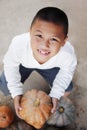 Portrait of happy child boy selecting pumpkin from organic farm market for Halloween decoration Royalty Free Stock Photo