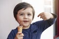 Portrait of happy child with dirty face eating an ice cream, Selective focus Kid boy smiling with messy mouth standing next to the