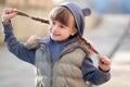 Portrait of happy child girl with hair braids in warm clothes in autumn outdoors Royalty Free Stock Photo