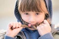 Portrait of happy child girl with hair braids in warm clothes in autumn outdoors Royalty Free Stock Photo