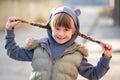 Portrait of happy child girl with hair braids in warm clothes in autumn outdoors Royalty Free Stock Photo