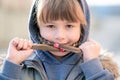 Portrait of happy child girl with hair braids in warm clothes in autumn outdoors Royalty Free Stock Photo