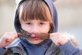 Portrait of happy child girl with hair braids in warm clothes in autumn outdoors Royalty Free Stock Photo