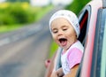 Portrait of happy child girl sticking their head out the car win Royalty Free Stock Photo