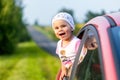 Portrait of happy child girl sticking their head out the car win Royalty Free Stock Photo