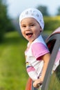 Portrait of happy child girl sticking their head out the car win Royalty Free Stock Photo