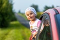 Portrait of happy child girl sticking their head out the car win Royalty Free Stock Photo