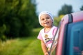 Portrait of happy child girl sticking their head out the car win Royalty Free Stock Photo