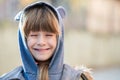 Portrait of happy child girl in warm clothes in autumn outdoors Royalty Free Stock Photo