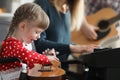 Happy child playing guitar, learn new song on musical instrument Royalty Free Stock Photo