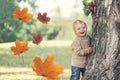 Portrait of happy child playing having fun in warm autumn day